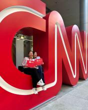 Students sitting on the CNN letters